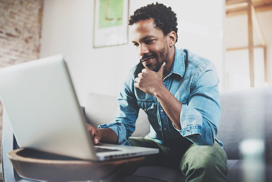 happy man looking at the laptop